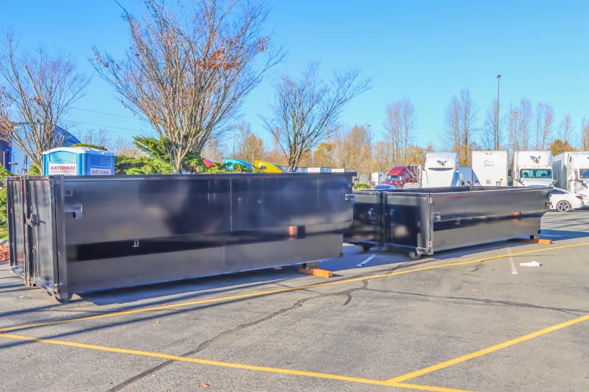 Professional dumpster rental service with roll-off container on residential driveway in Cornwall